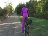 Watch Sandra riding her Bike in her sexy pink shiny nylon Rainsuit 6