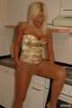 Natural busty Martina posing in a golden corsage, black leggins, pantyhose and heels in the kitchen 7