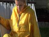 Watch Chloe enjoying the warm Sun in her yellow shiny nylon Rainsuit  7