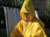 Watch Chloe enjoying the warm Sun in her yellow shiny nylon Rainsuit  8