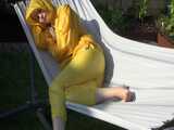 Watch Chloe enjoying the warm Sun in her yellow shiny nylon Rainsuit  9